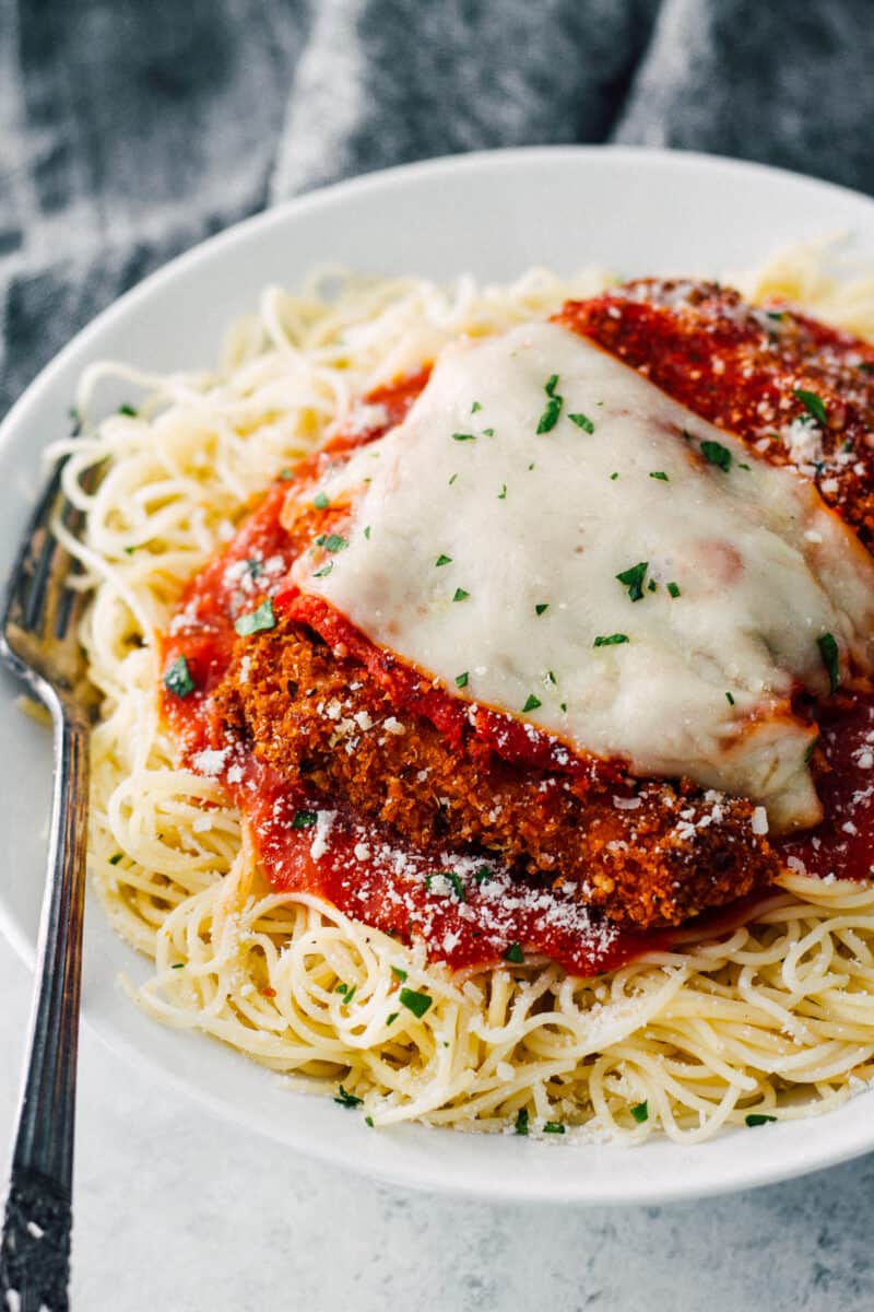 easy chicken parmesan over sauce and pasta