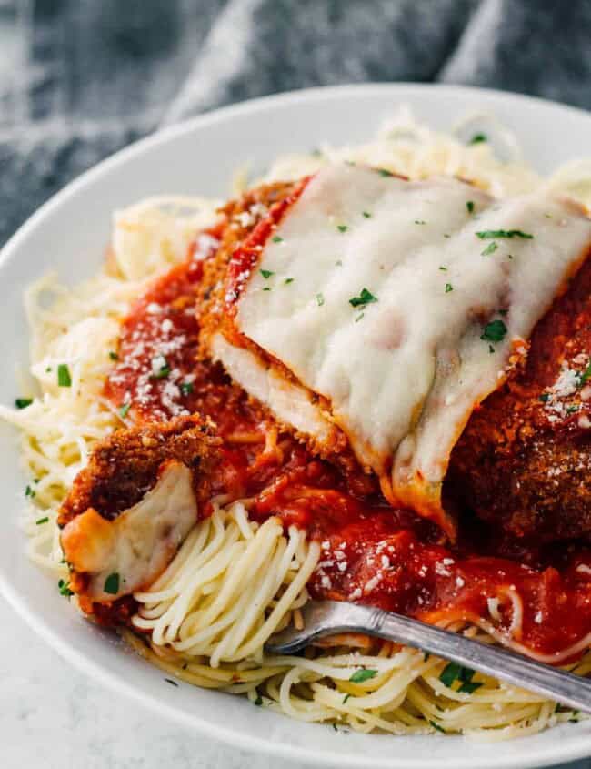 easy chicken parmesan over sauce and pasta