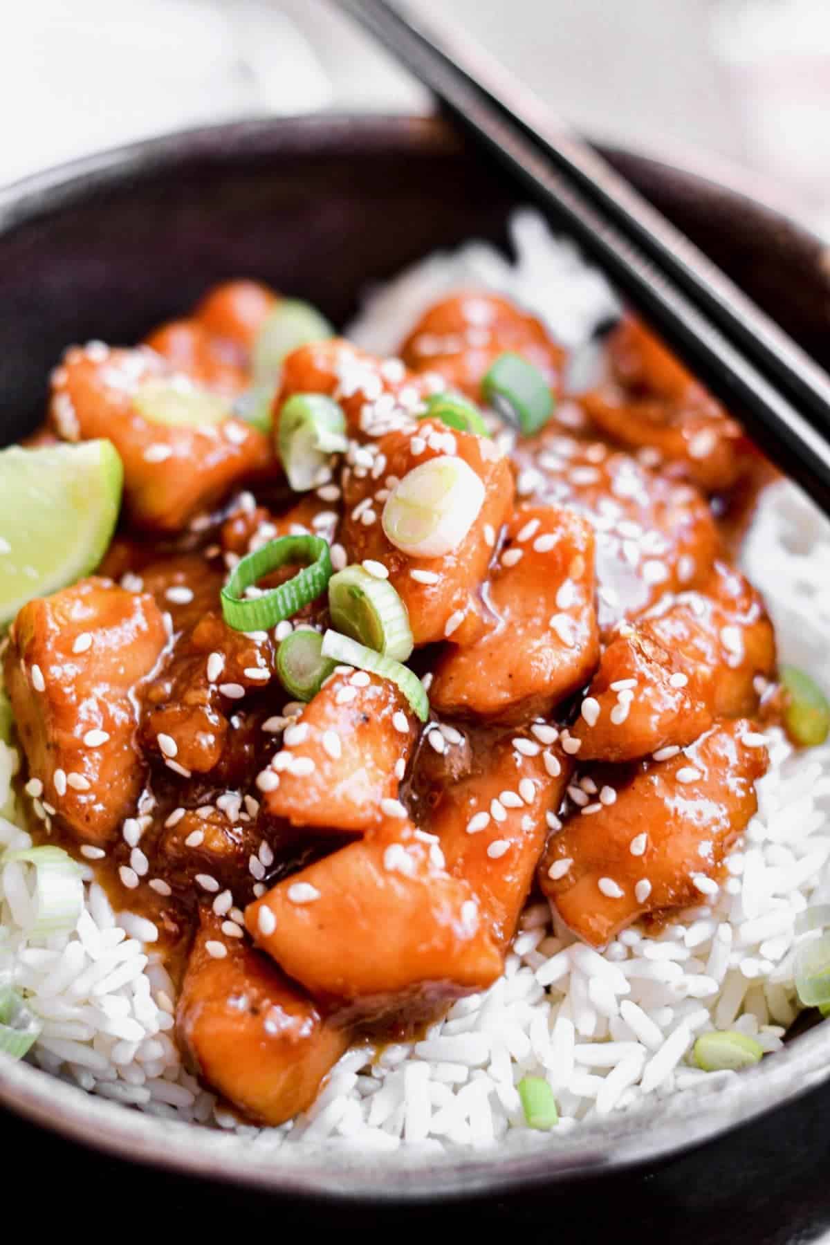 Close up of orange chicken on top of rice