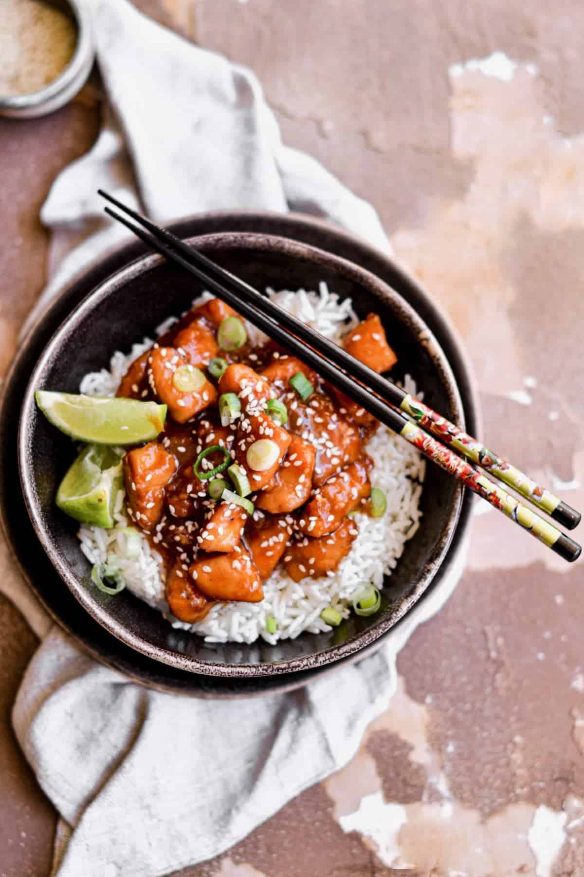 Orange chicken served in a bowl with rice
