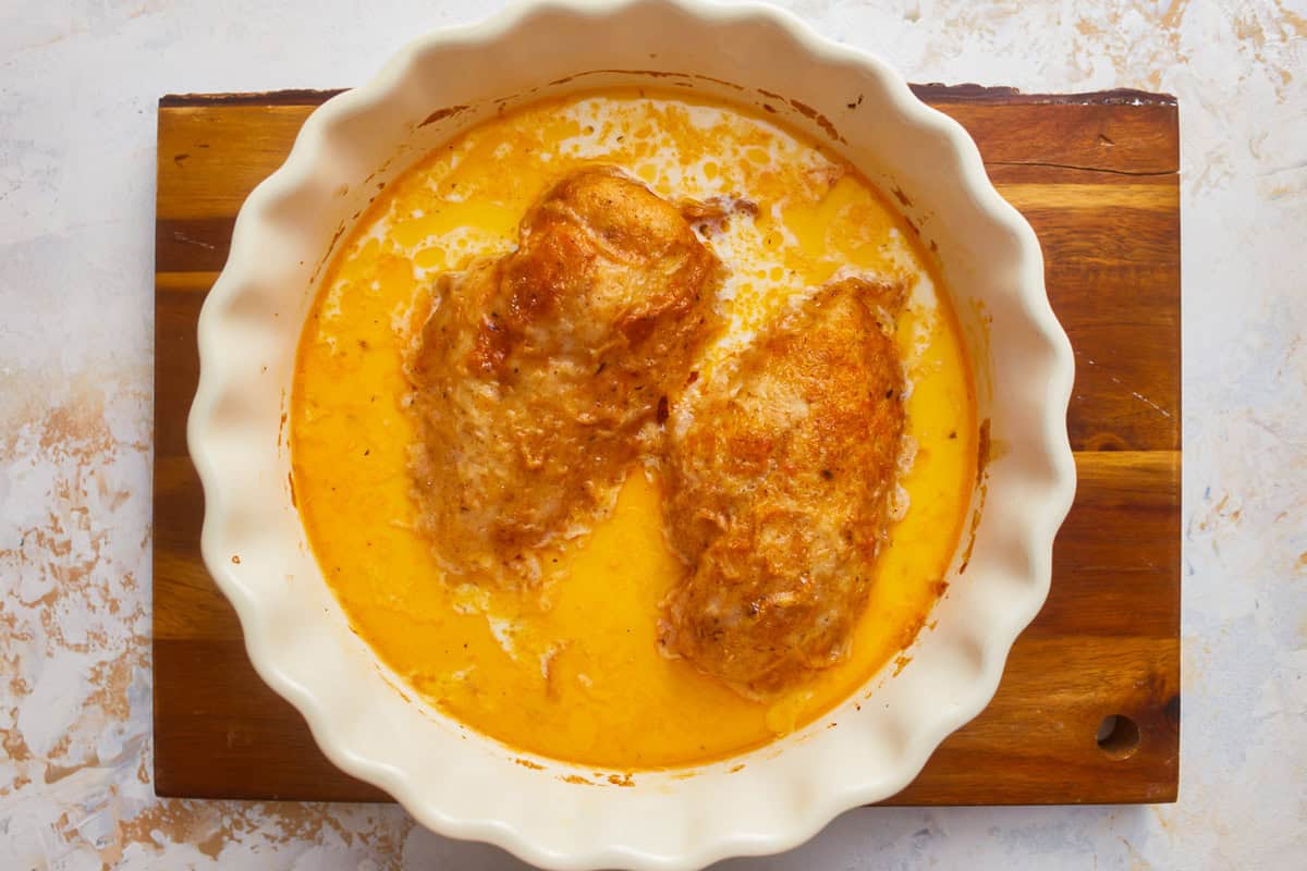 butter baked chicken breasts in a baking dish.