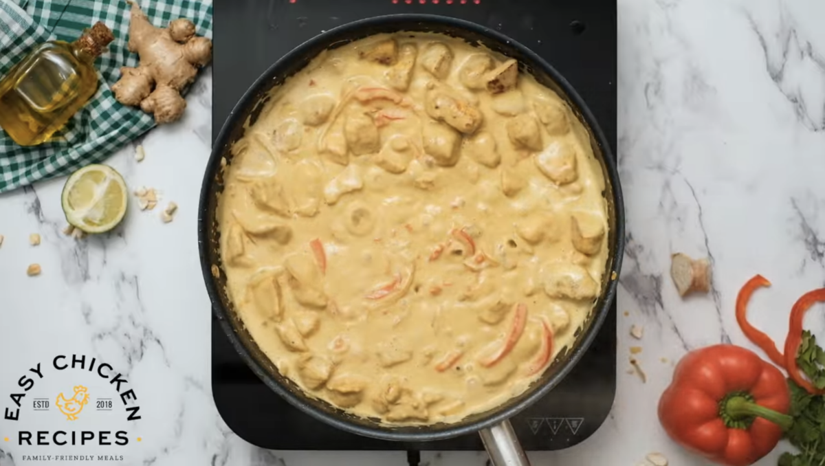 Chicken curry has been thickened and is creamy in a skillet. 