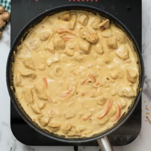 Chicken curry has been thickened and is creamy in a skillet.