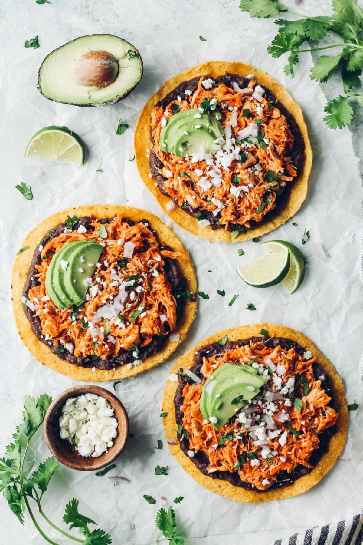 Chicken tinga served on tostadas with refried beans