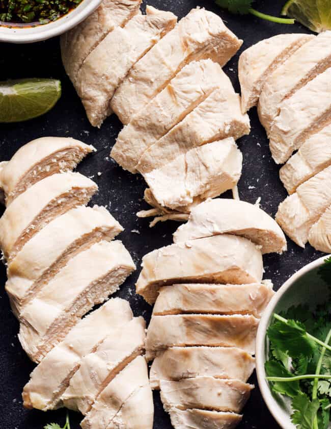 how to poach chicken - sliced poached chicken on plate