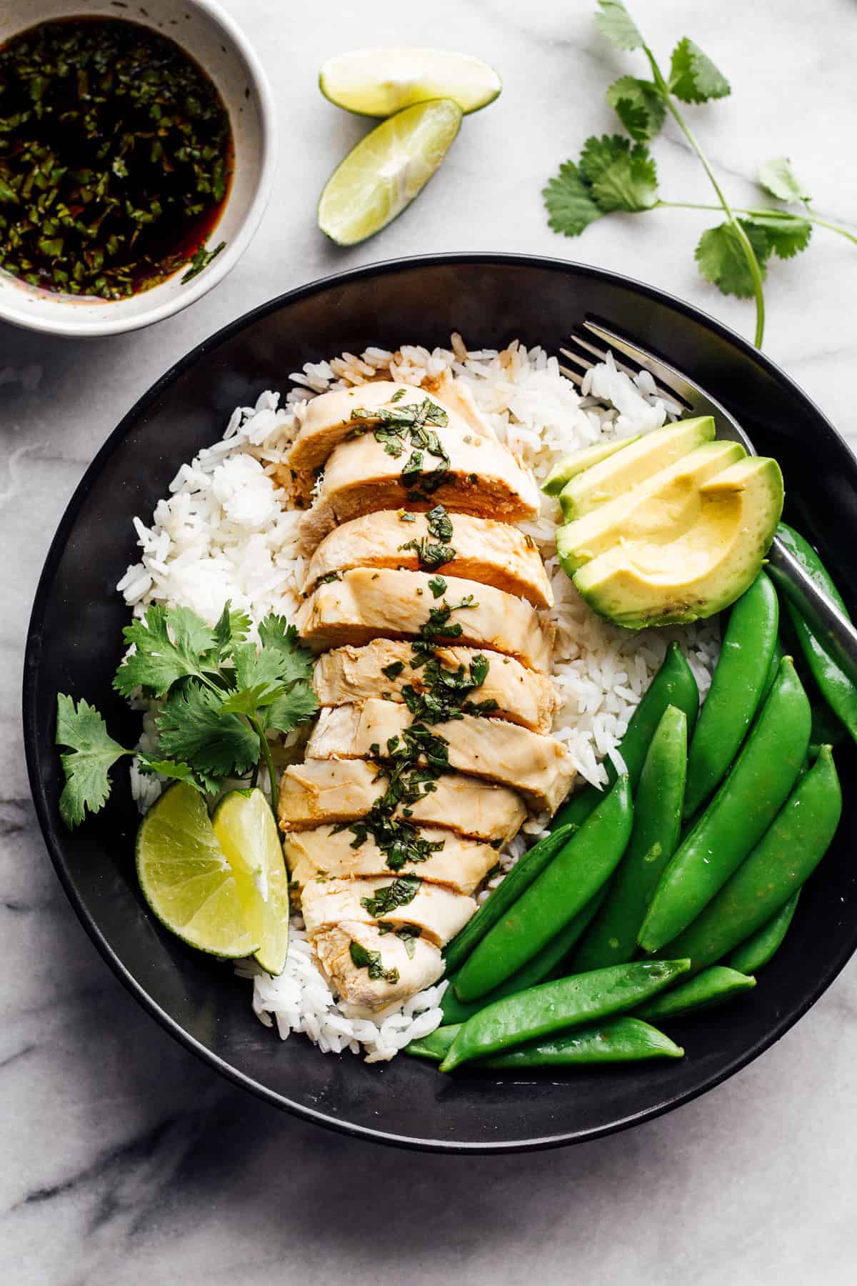 poached chicken with rice and green beans on plate