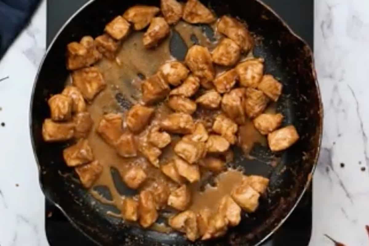 cooked marinated chicken pieces in a skillet.