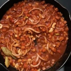 simmering butter chicken sauce in a skillet.