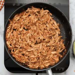 Quick and delicious chicken tinga recipe cooked in a frying pan.