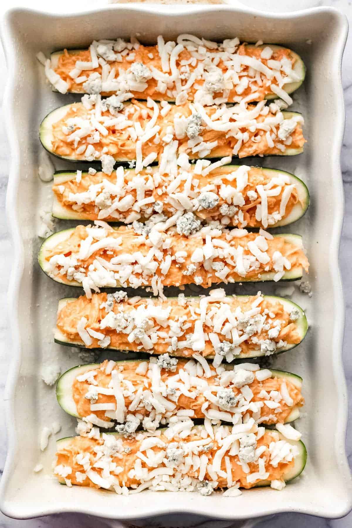 cheese sprinkled on zucchini boats