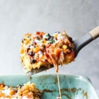 lifting up a spoonful of chicken tamale casserole
