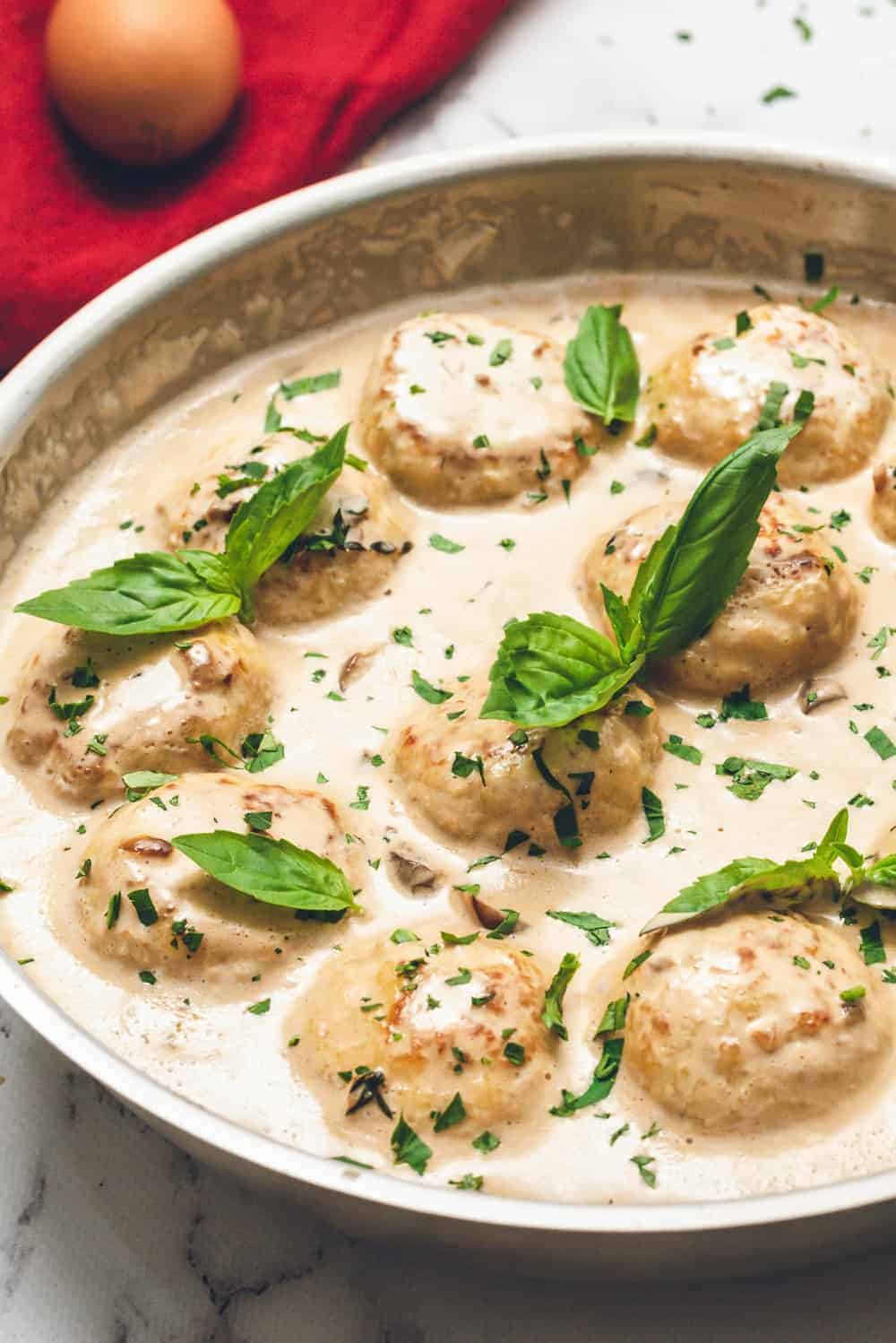 up close picture of meatballs in cream sauce