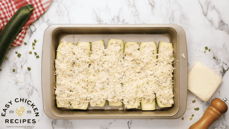 Uncooked zucchini boats are placed on a baking sheet.