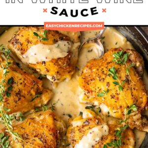 Chicken in a white wine sauce and skillet.