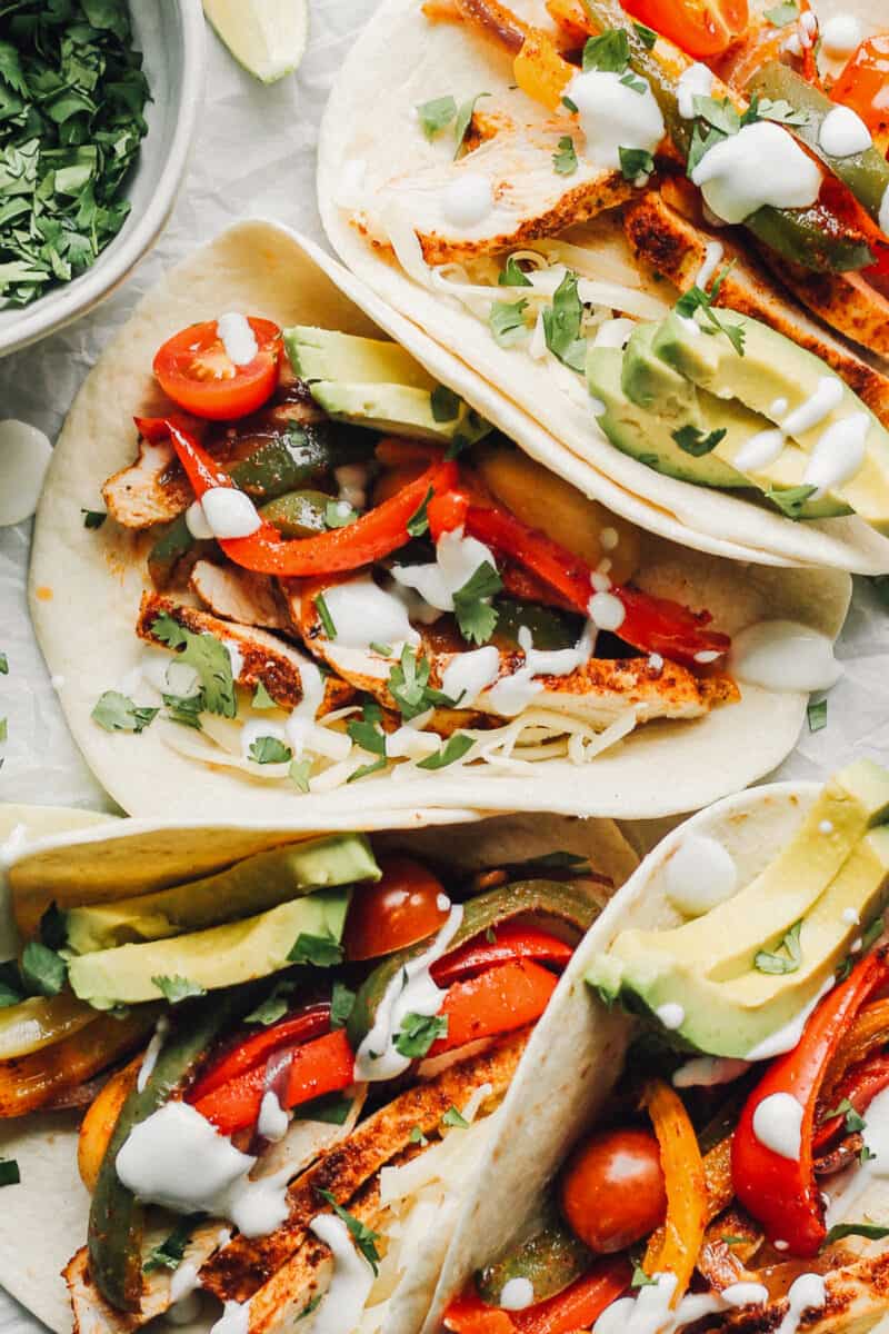 up close image of 4 tortillas stuffed with chicken fajitas
