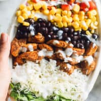 hand holding up copycat chipotle chicken burrito bowl