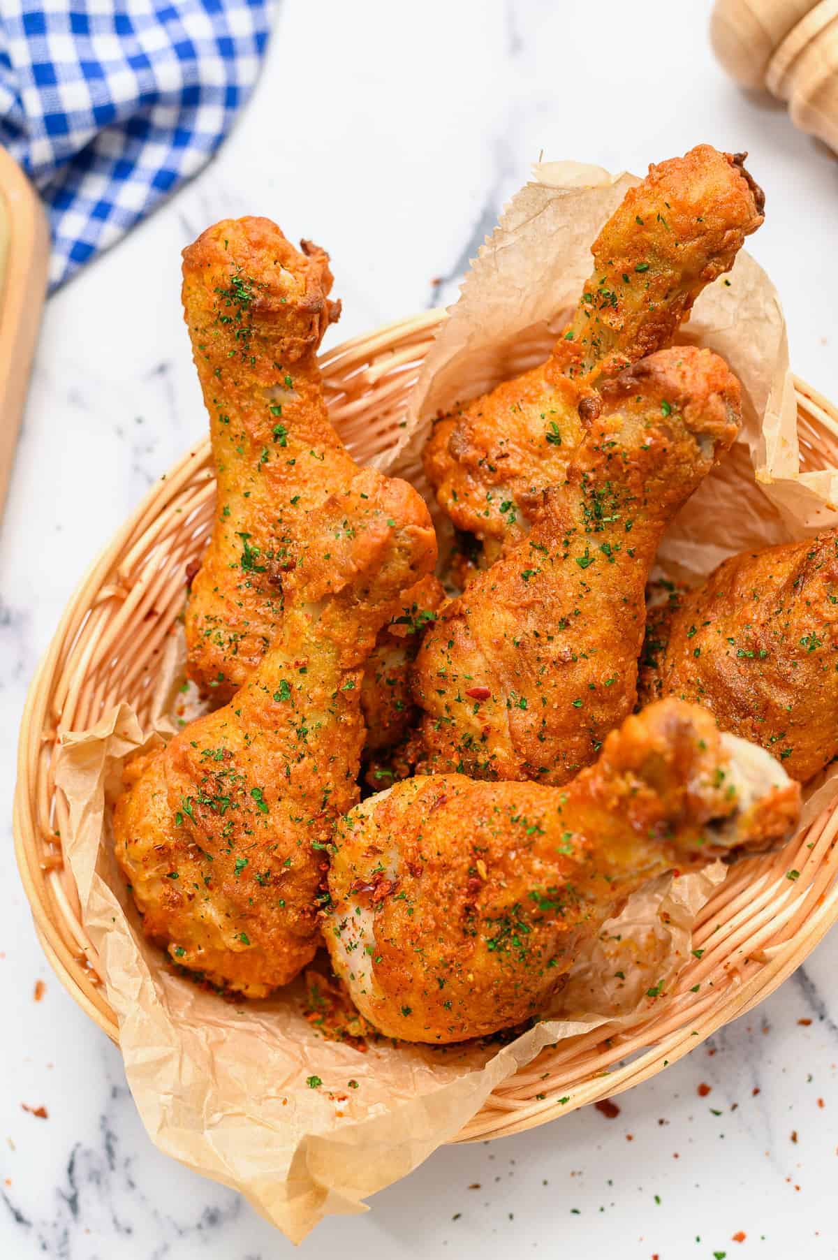 oven fried chicken in basket with parchment