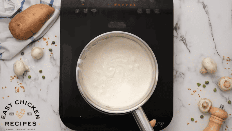 A creamy roux is in a small saucepan.