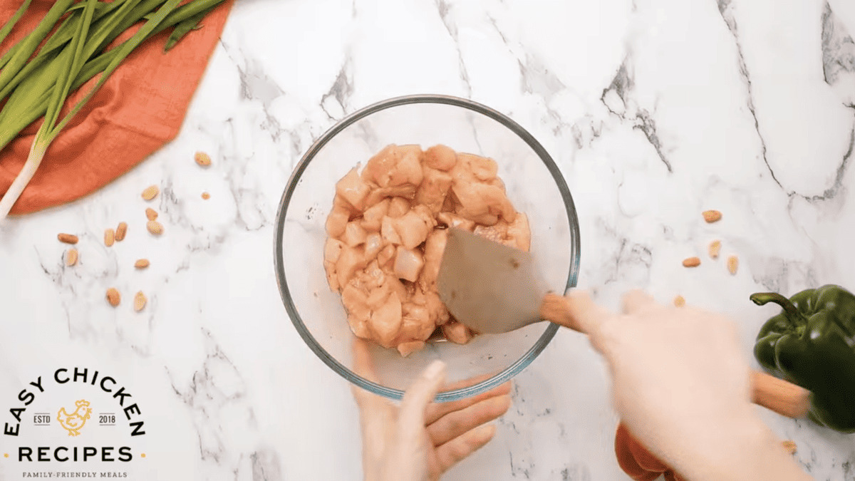 Chicken breasts are marinating in a bowl. 