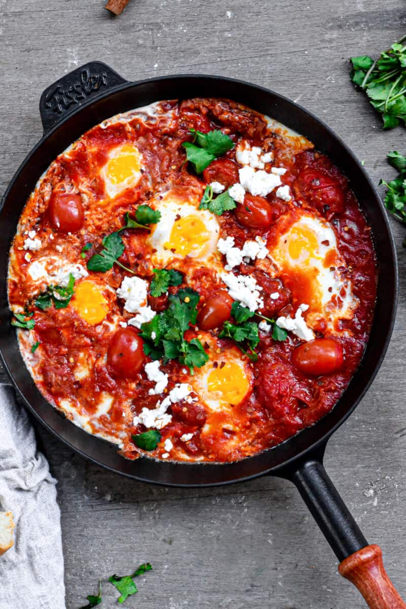 skillet with eggs and tomato