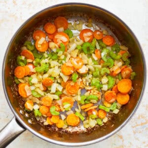 flour-coated sautéed veggies in a pot.