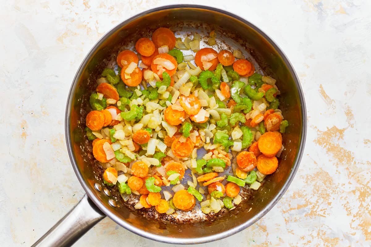 flour-coated sautéed veggies in a pot.