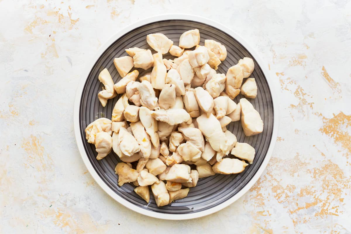 cubed cooked chicken breast on a plate.