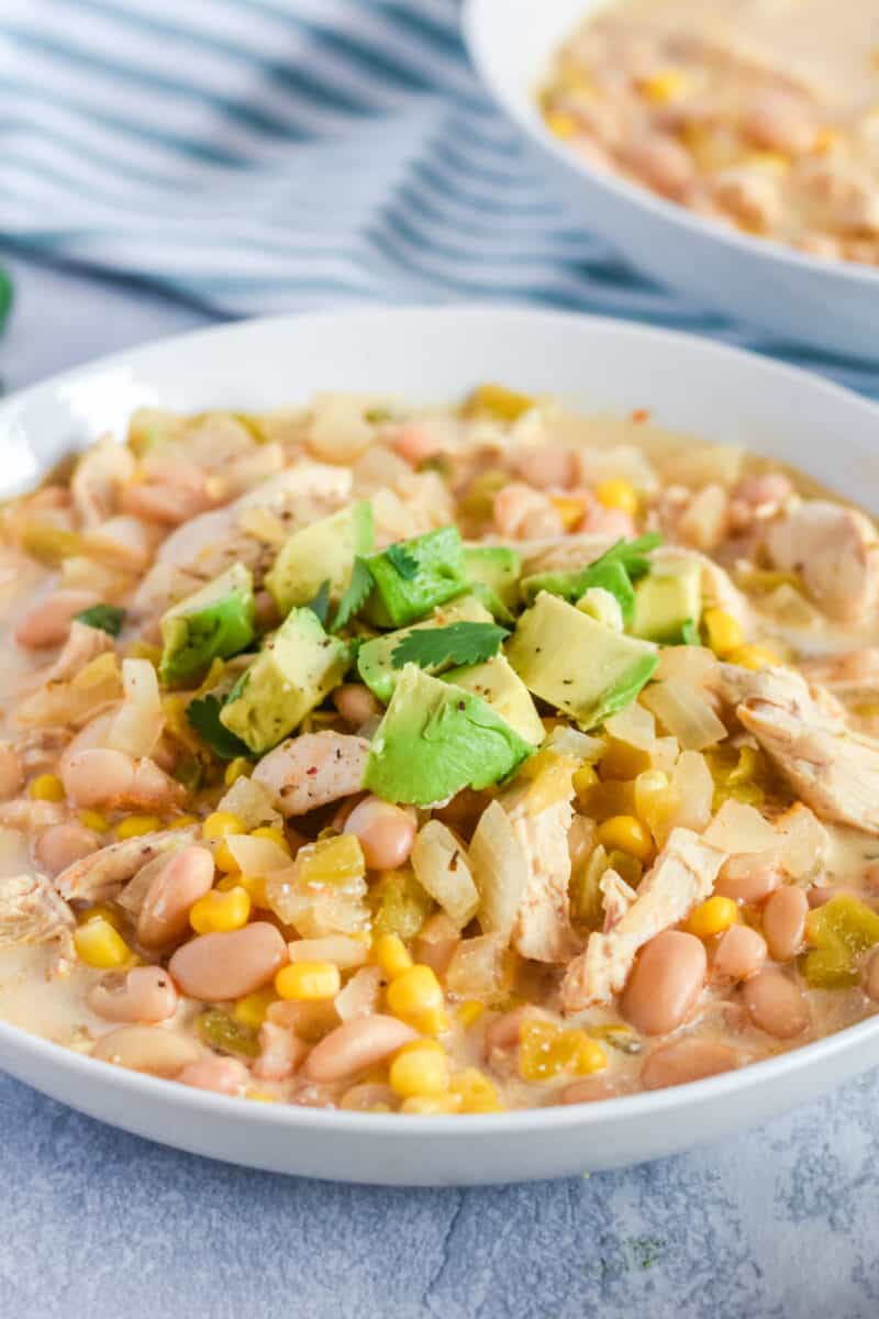bowl of easy white chicken chili with avocadoes