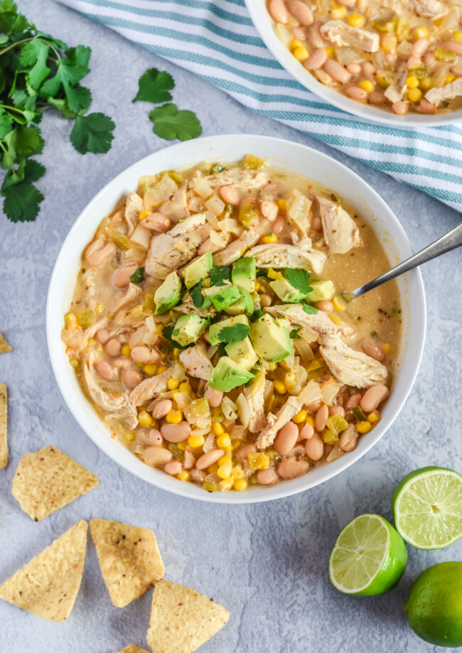 white chicken chili in bowl garnished with avocado