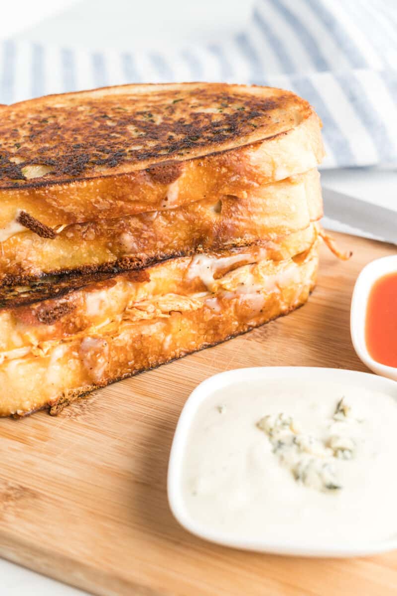 Buffalo Chicken Grilled Cheese next to a blue cheese dipping sauce