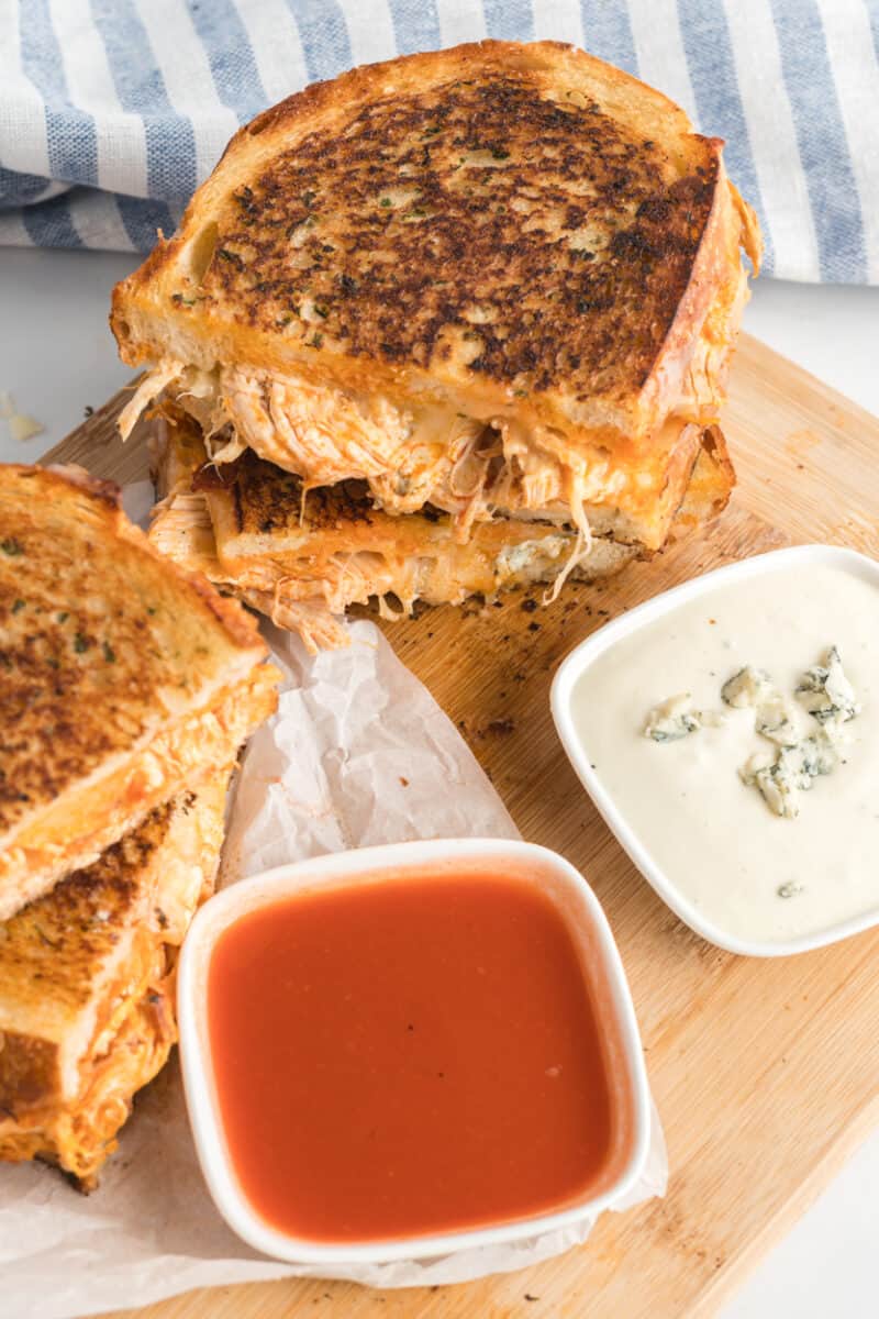 Buffalo Chicken Grilled Cheese sandwiches next to two dipping sauces