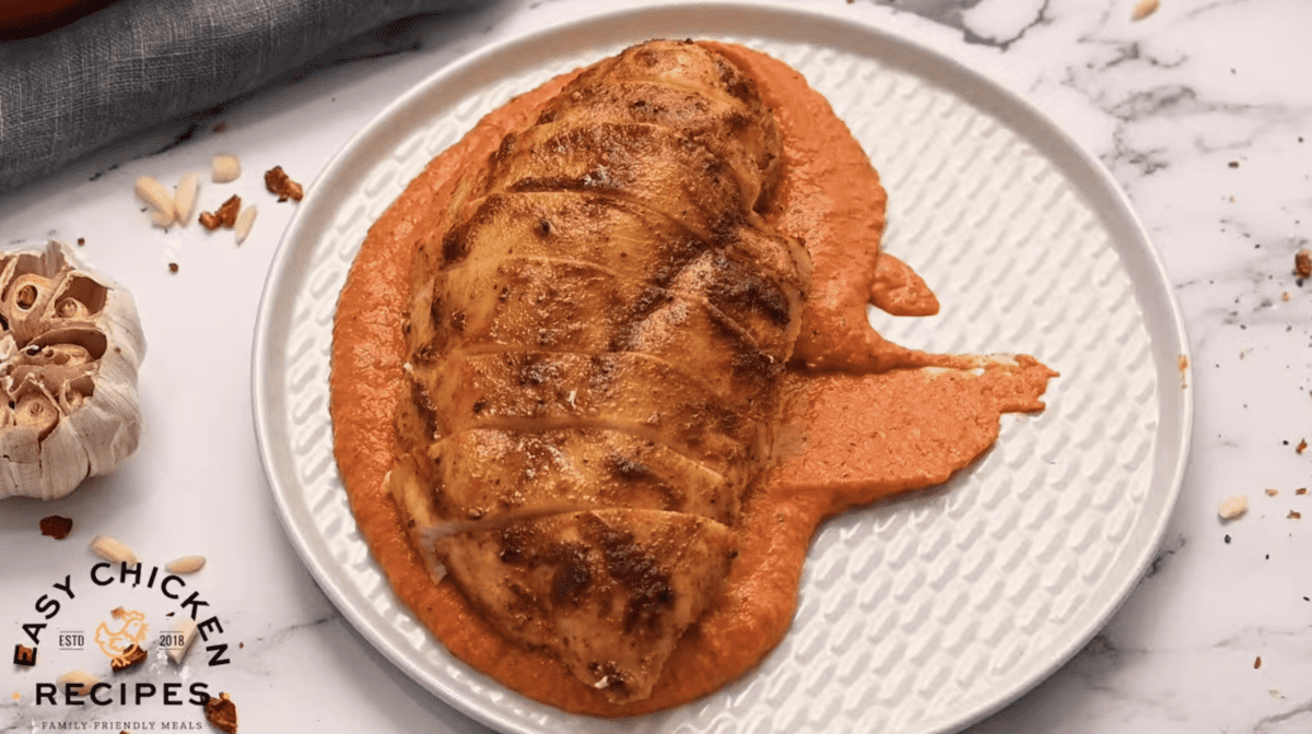 Romesco chicken breast served on a plate.
