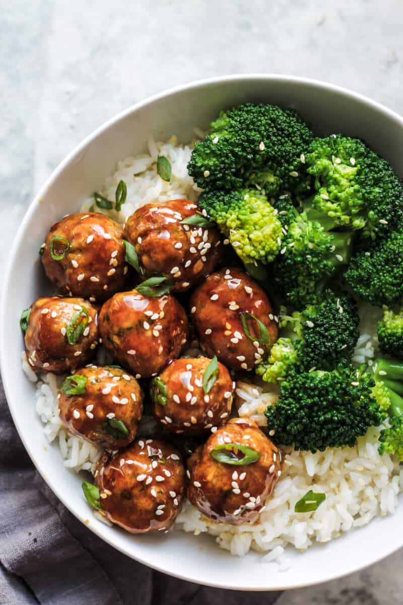 Asian chicken meatballs served with rice and broccoli 