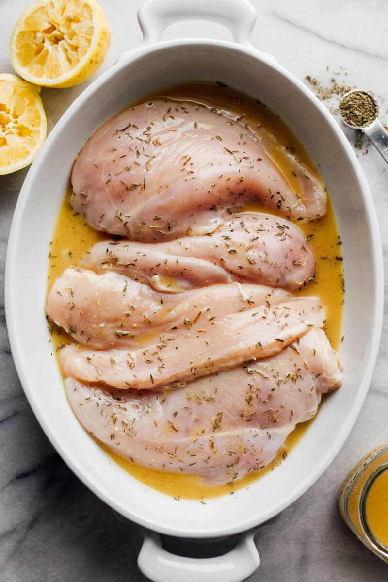 chicken breasts in baking dish with lemon sauce