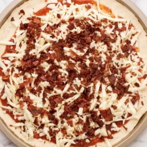 overhead view of a pizza topped with bacon crumbles.