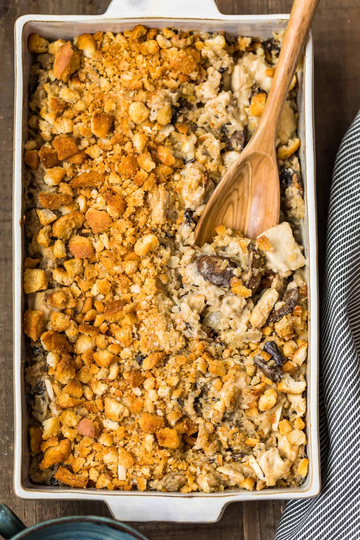 a chicken wild rice casserole with a wooden spoon in it.