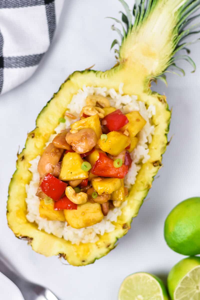 Pineapple chicken served with rice in a pineapple