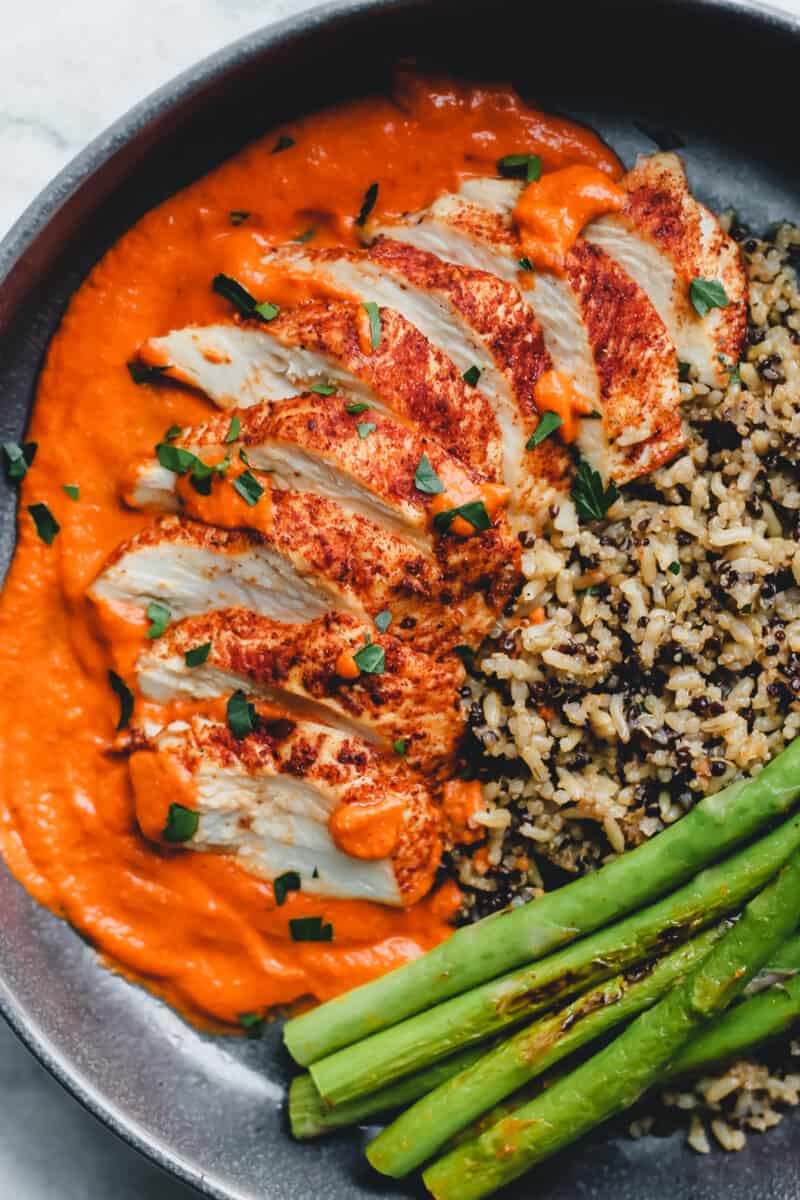 Romesco chicken served with rice and asparagus