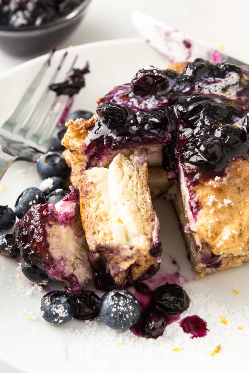 french toast stuffed with cream cheese on plate with blueberry sauce