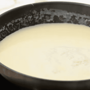 White sauce is in a skillet.