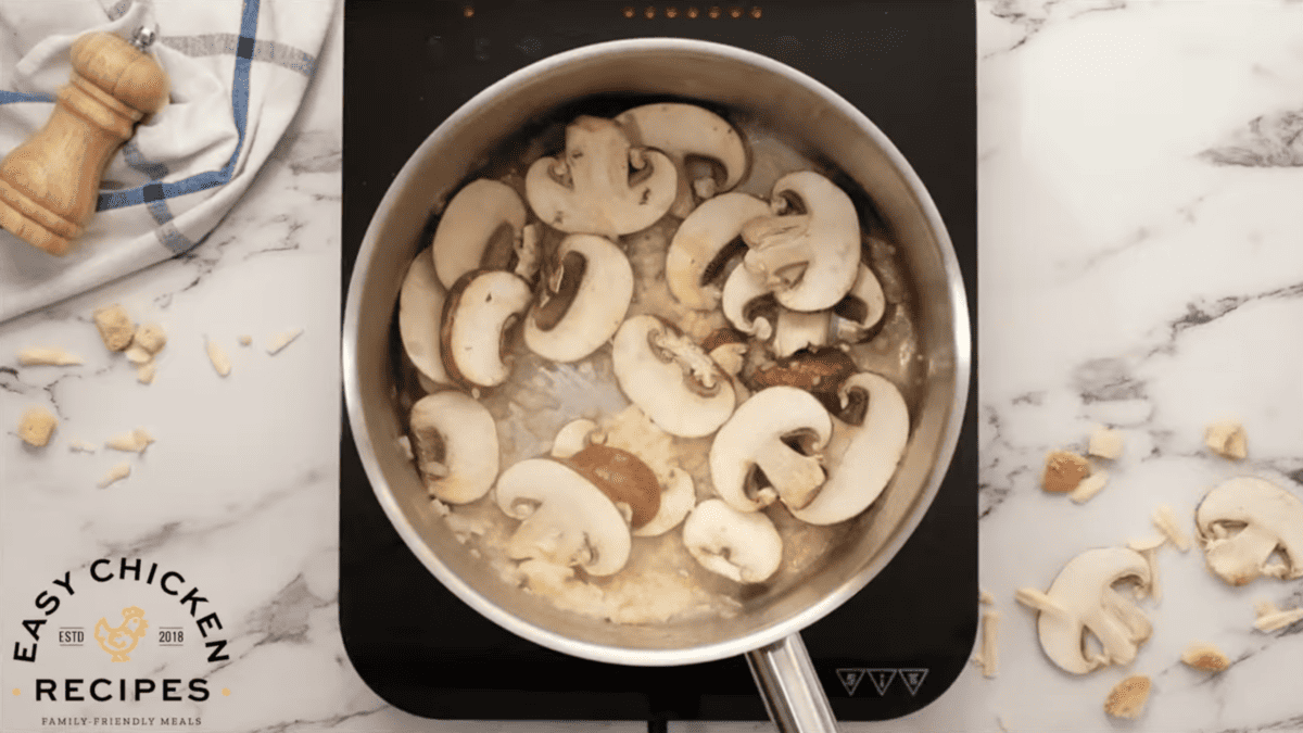 mushrooms and onions are cooking in a skillet