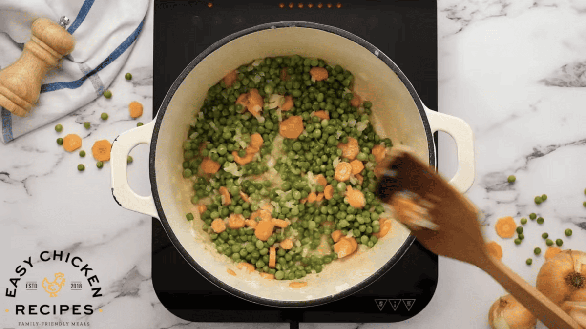 A pot is filled with peas and carrots.