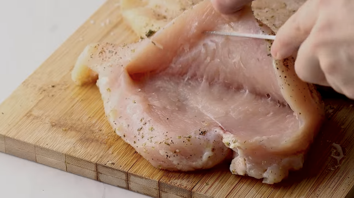 A chicken breast has been sliced to form a pocket.