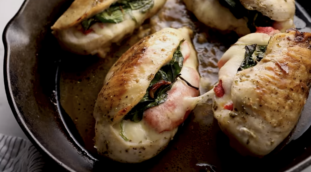 Cooked chicken breasts are in a skillet. 