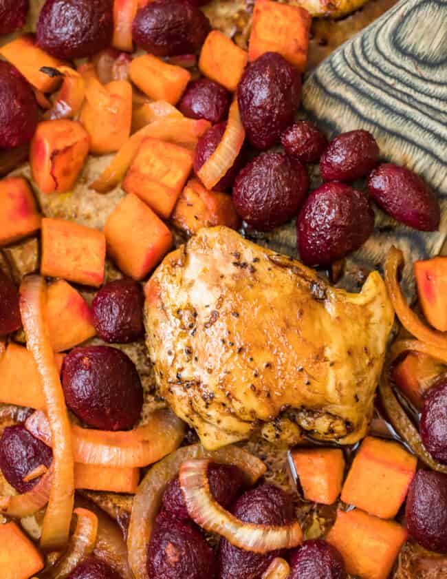 Roasted chicken with beets and carrots on a sheet pan.