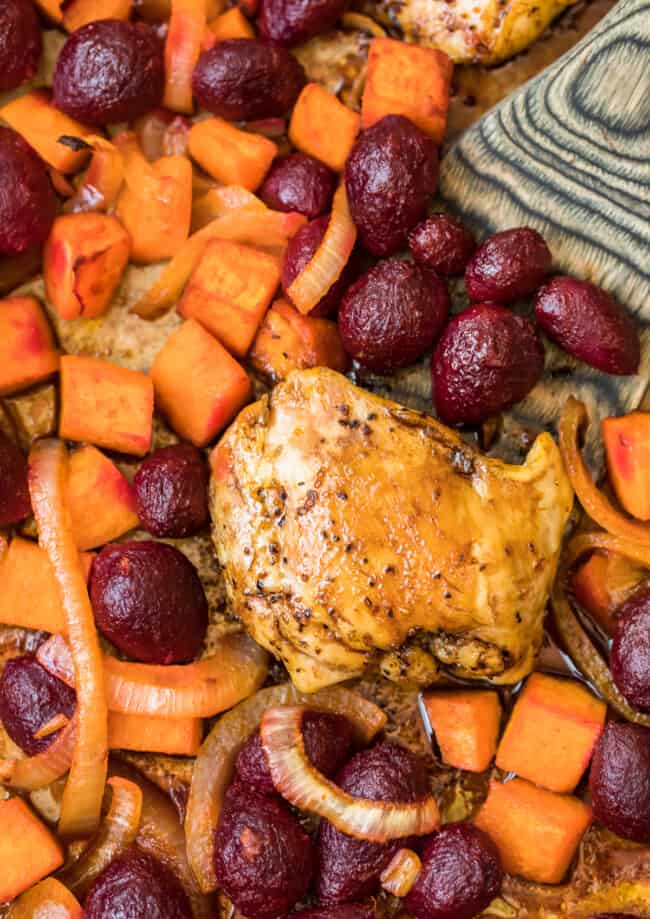 Roasted chicken with beets and carrots on a sheet pan.