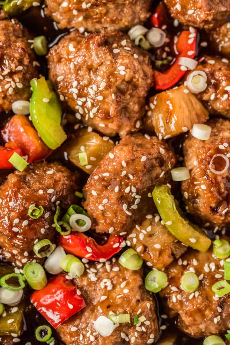 up close picture of chicken meatballs with pineapple and peppers