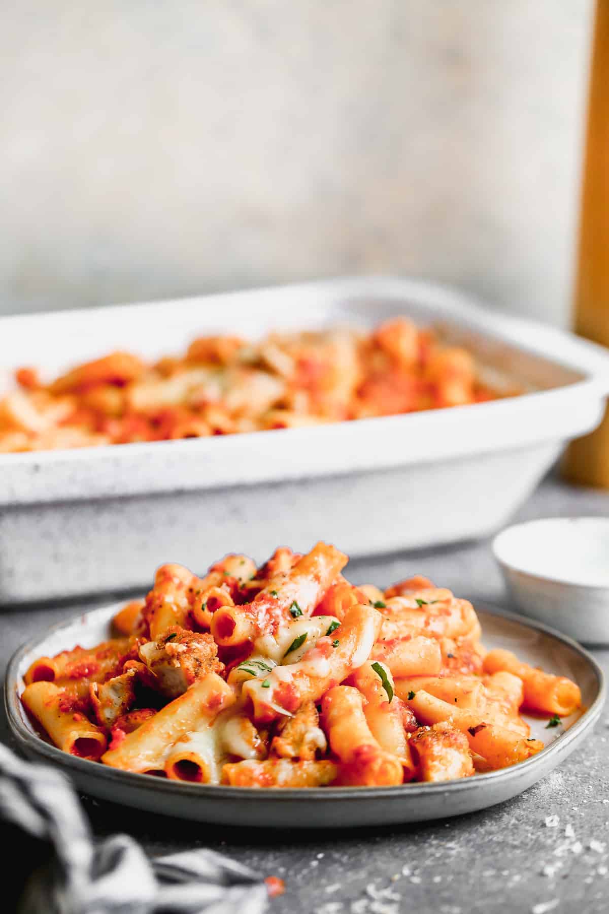 A plate of baked ziti with chicken parmesan.