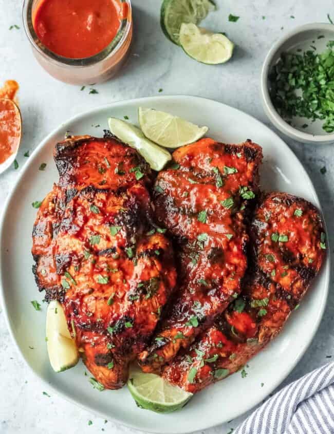 grilled chipotle chicken on plate with limes