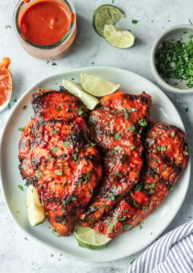 grilled chipotle chicken on plate with limes